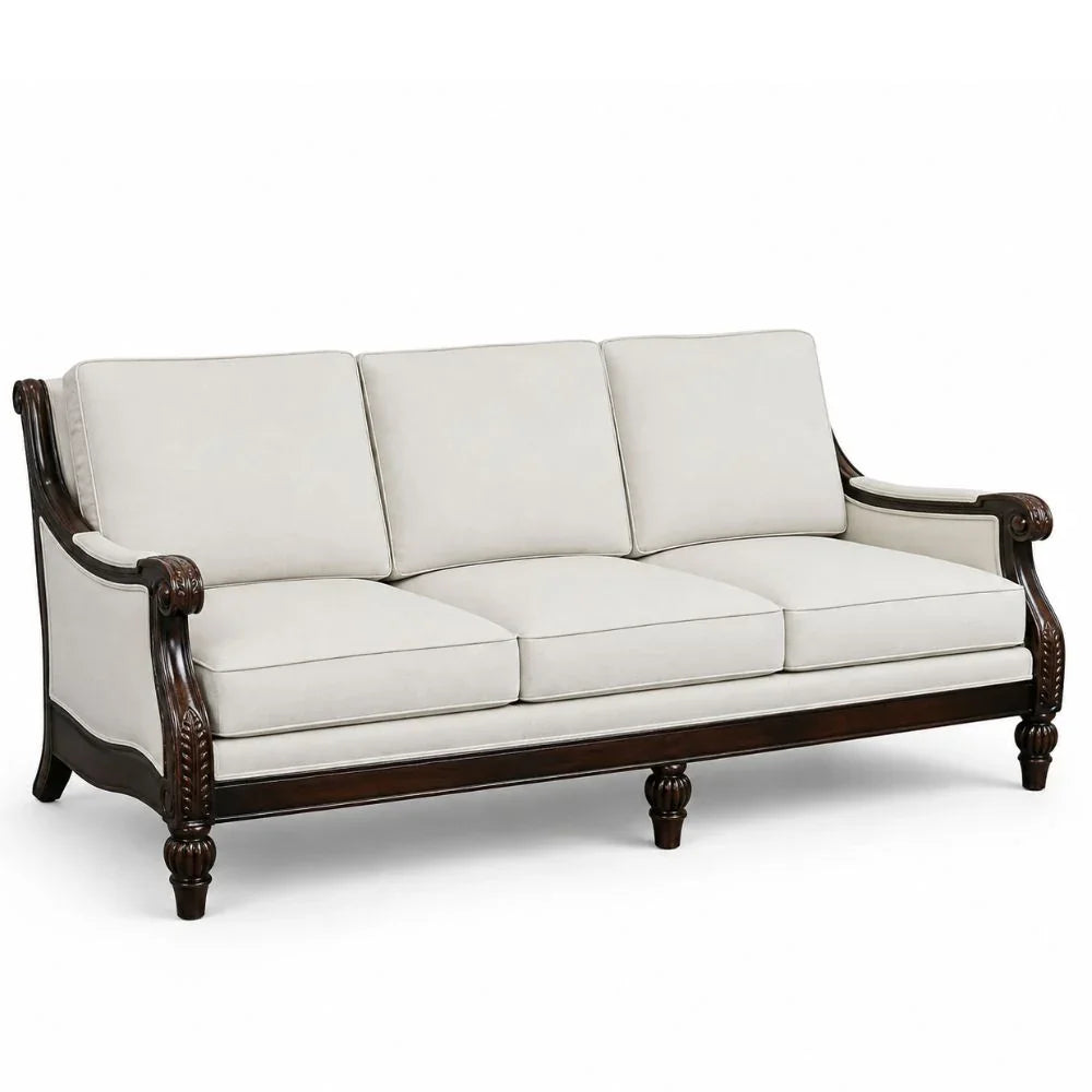 Elegant French country sofa with carved dark wood frame and cream upholstery, perfect for farmhouse or shabby chic decor