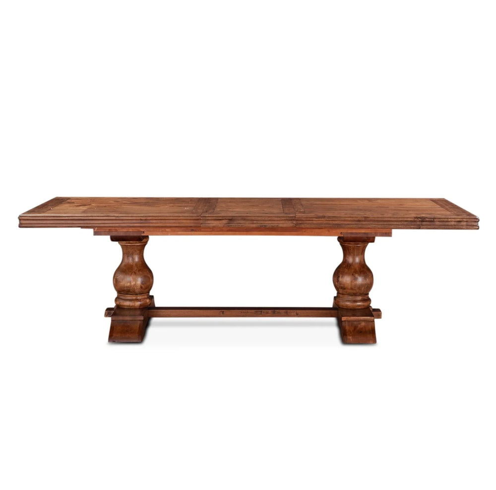 Rustic farmhouse wooden dining table with thick turned pedestal legs in a warm brown finish.