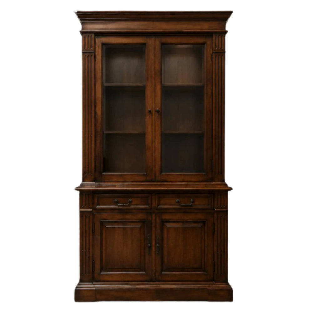 Antique dark wood china cabinet with glass doors and storage drawers in French country style.
