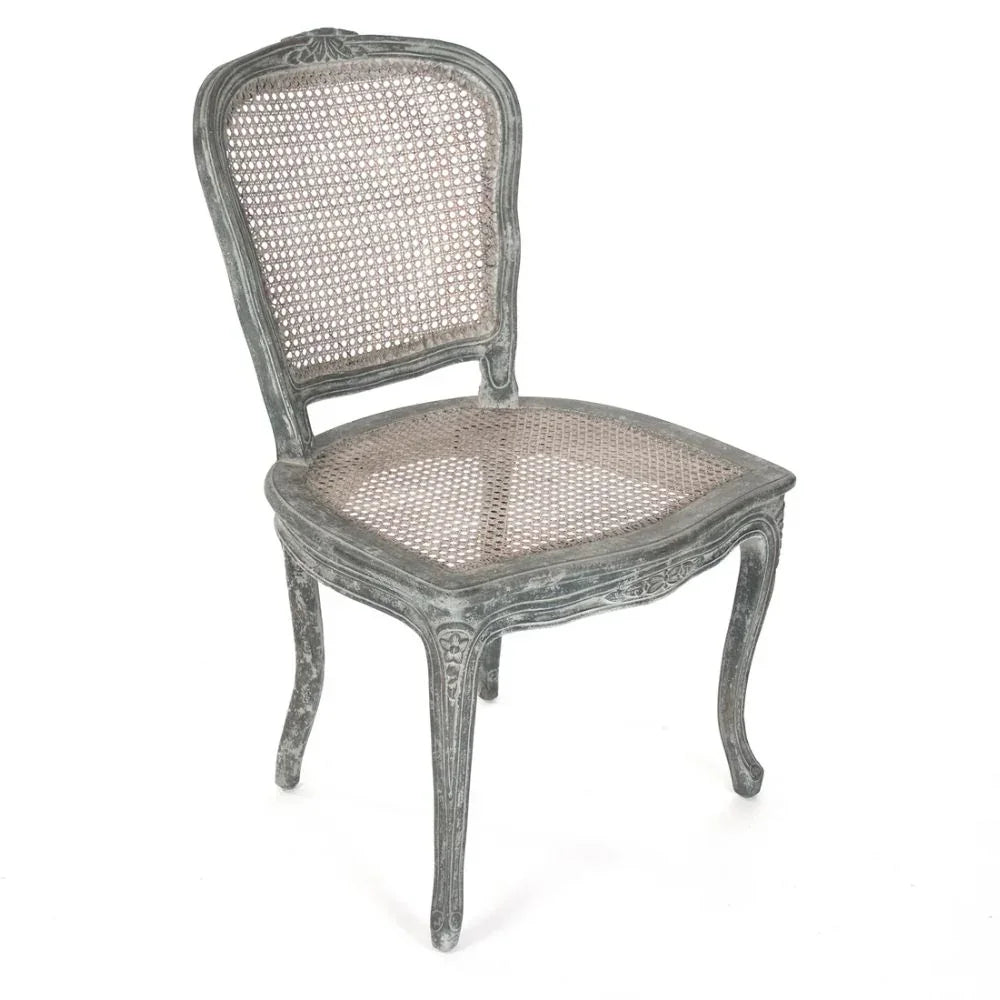 Distressed gray French country cane chair with ornate legs and back, shabby chic style