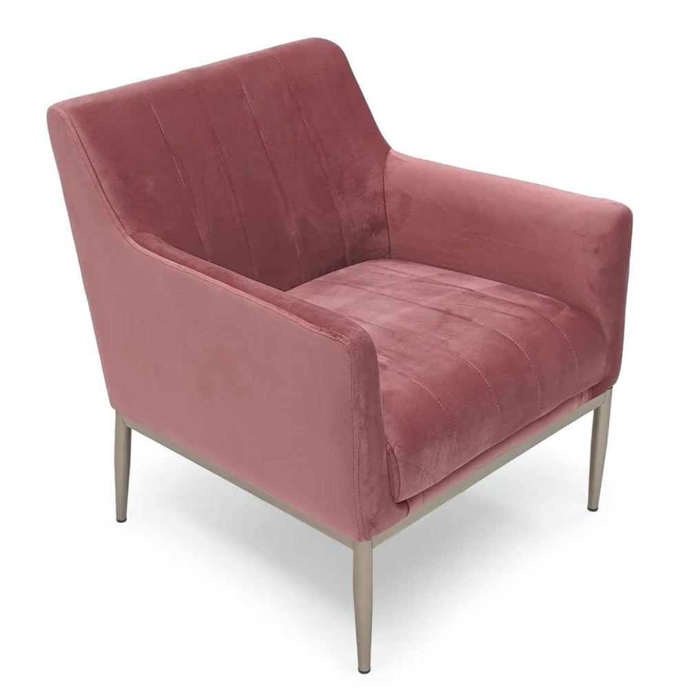Dusty rose velvet armchair with vertical channel stitching and slim metal legs in modern style.