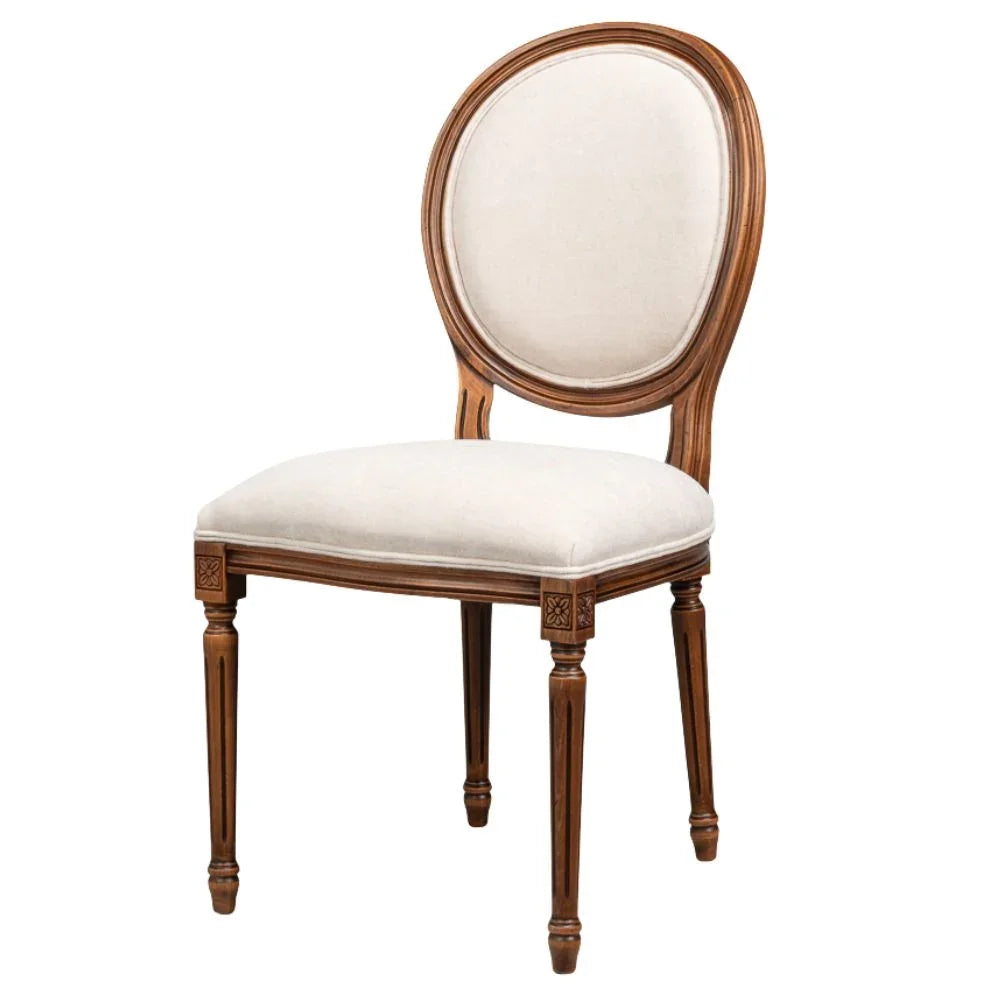 Elegant French country Louis dining chair with oval back, cream upholstery, rosette carvings, and fluted legs