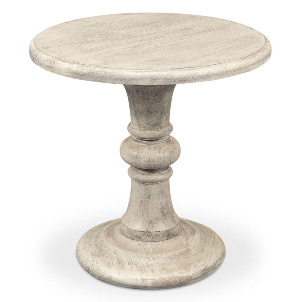 Small round pedestal side table in a distressed white shabby chic style.