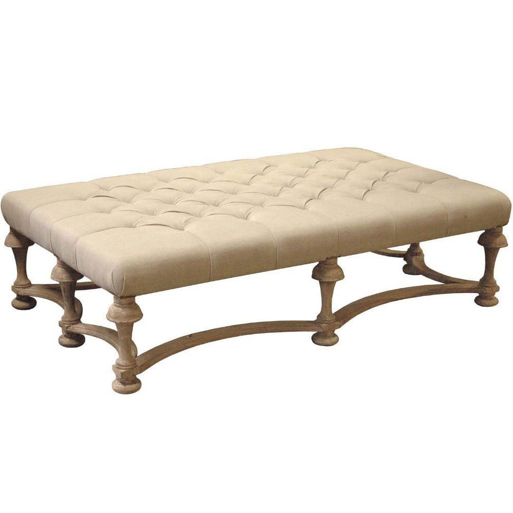 Tufted beige ottoman with ornate wooden legs in French country style