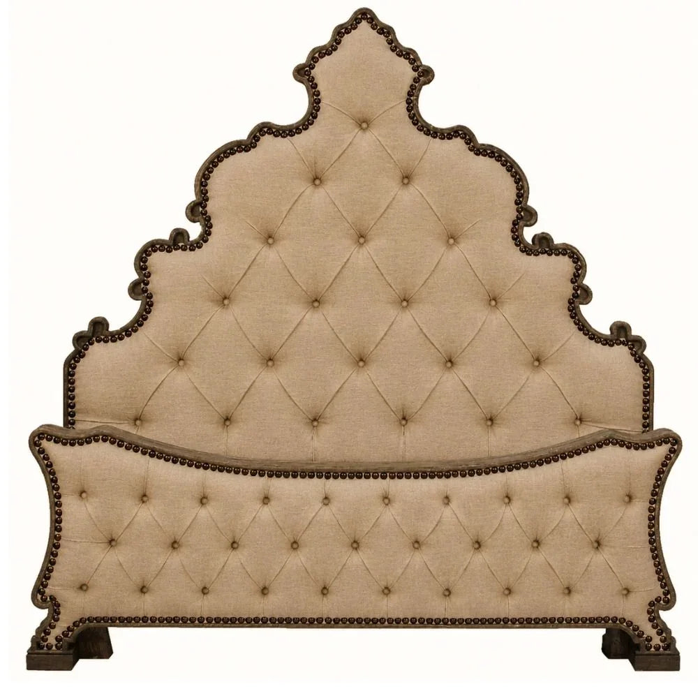 An ornate upholstered headboard with a tall, scalloped tufted backrest and a matching padded footboard, in warm beige fabric with dark brown nailhead trim and dark wooden feet, shown on a plain white background.