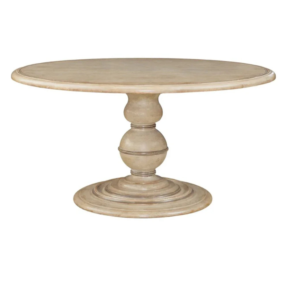 Round pedestal dining table in a light beige French country style.