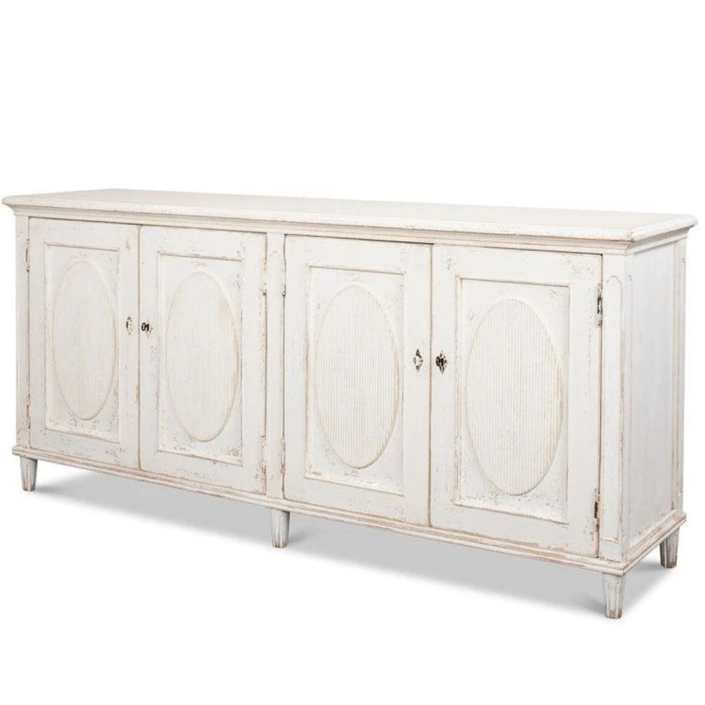 White distressed French country style sideboard with oval carved door panels.