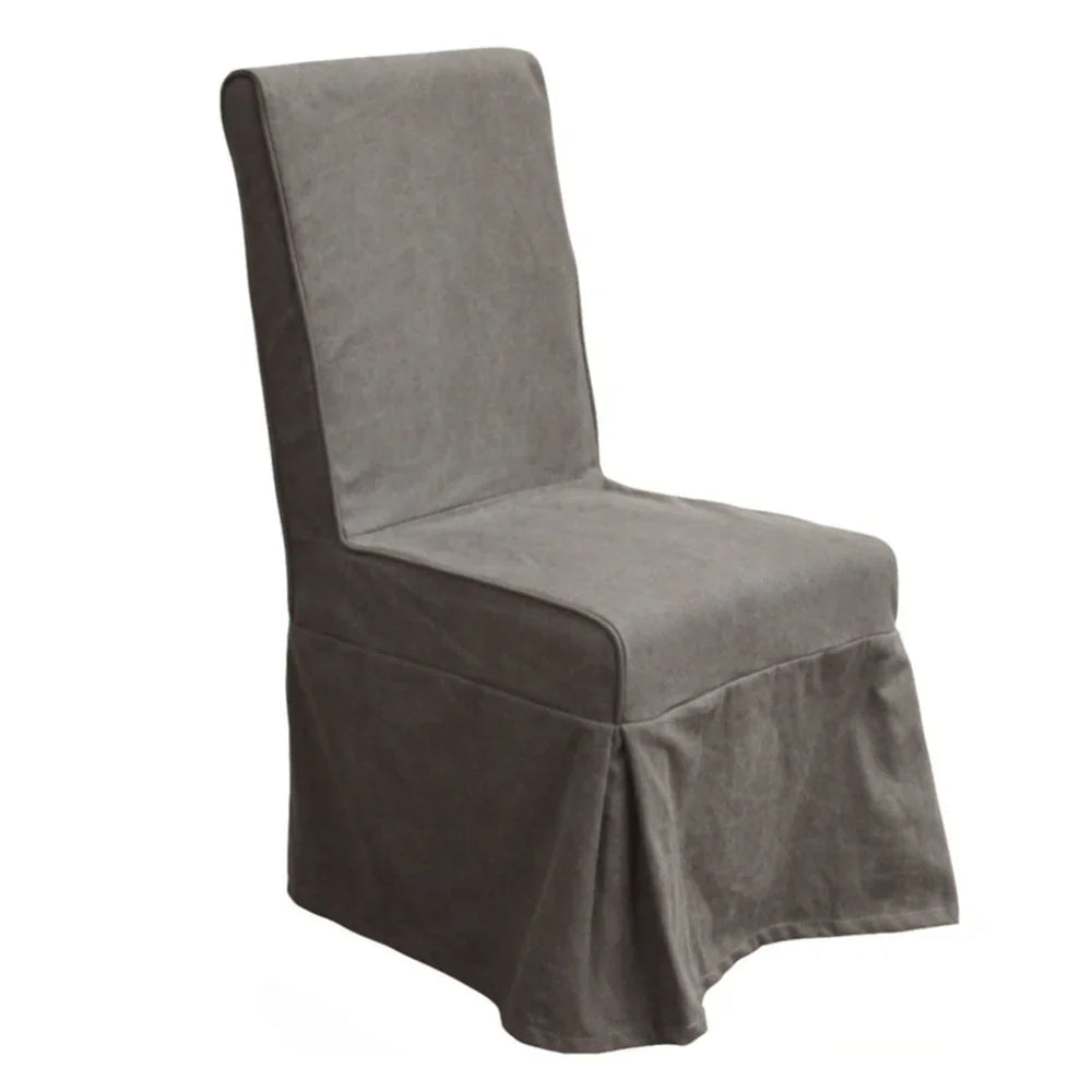 Grey fabric slipcovered dining chair in a farmhouse style with a skirted base.