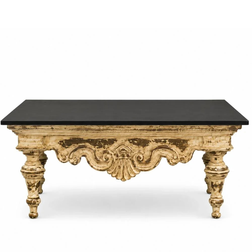 An ornate rectangular coffee table with a distressed gold-painted carved frame and a solid black top, shown against a plain white background.