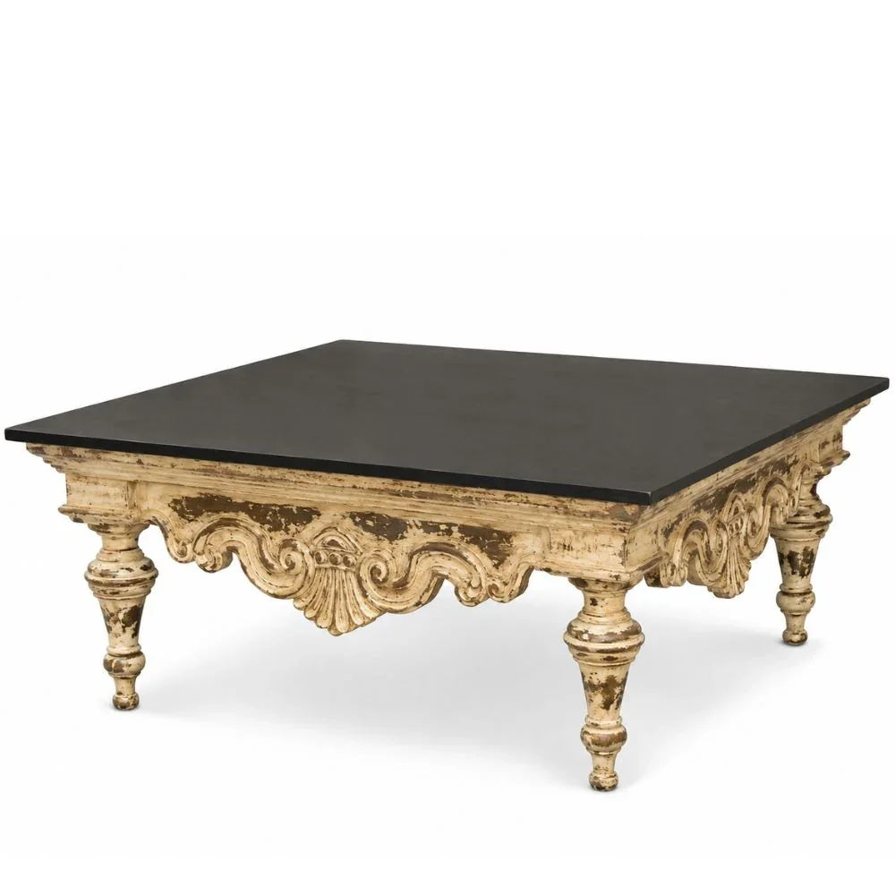 An ornate rectangular coffee table with a distressed gold carved frame and a solid black top, shown against a plain white background.