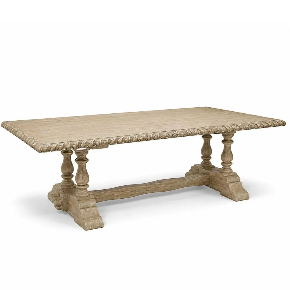 A rustic rectangular wooden dining table with a weathered beige finish, featuring a decorative rope-edge tabletop and turned pedestal legs connected by a stretcher bar, shown on a white background.