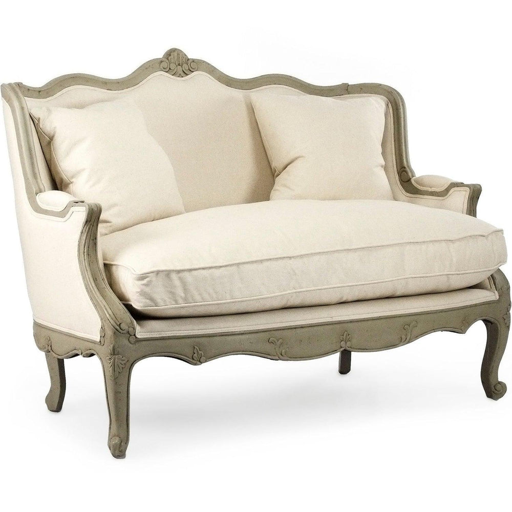 Elegant French country loveseat with cream upholstery and distressed gray frame, featuring ornate carvings and cabriole legs.