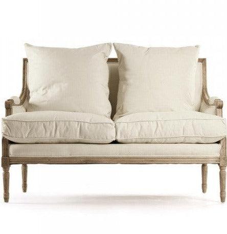 French country-style loveseat with cream cushions and distressed wood frame