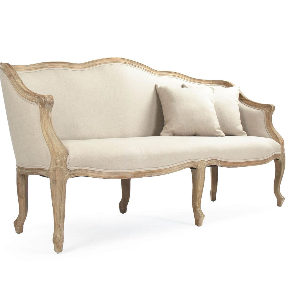 Elegant French country wood-framed settee with distressed wood frame and neutral linen upholstery, featuring curved back and cabriole legs
