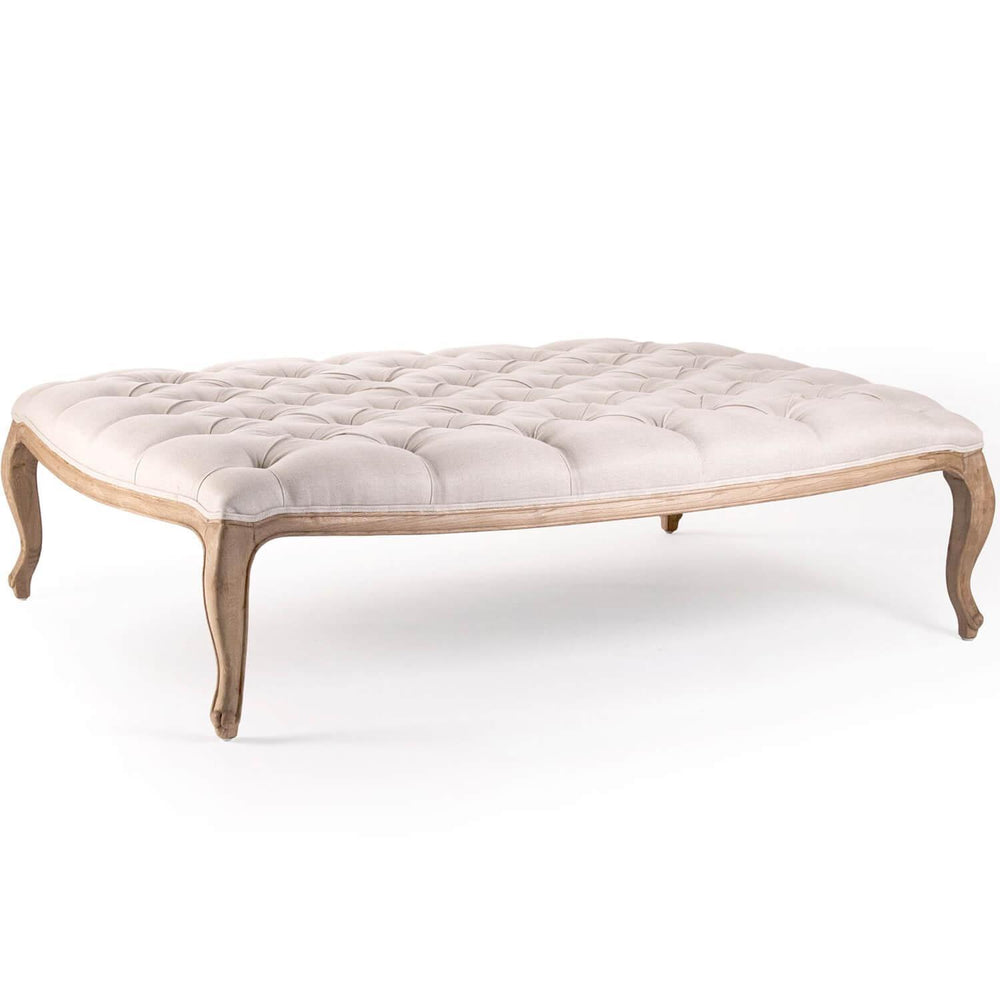 French country style tufted ottoman in cream fabric with a natural wood frame.
