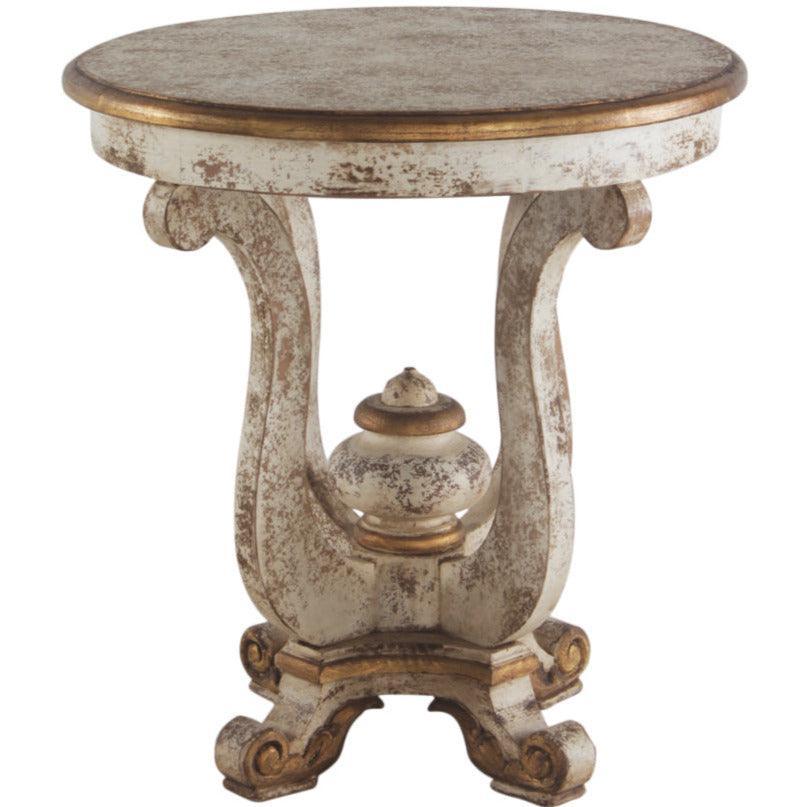 Round distressed white and gold French country pedestal side table with ornate scrolled legs.