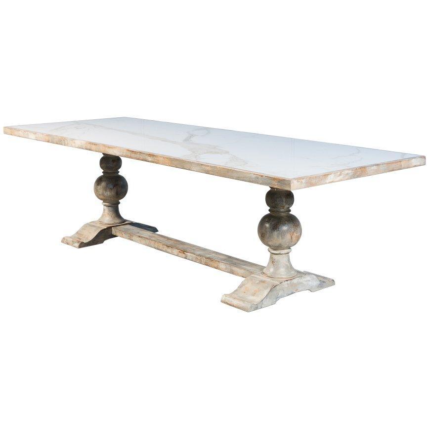 White marble top rectangular dining table with rustic carved pedestal legs in French country style